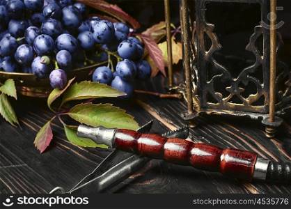 Hookah ,grapes and Arabic stylish lantern with candle