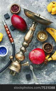 Hookah tobacco with the taste of mango, pomegranate and quince.Tobacco with the aroma of tropical fruits.Oriental smoking shisha. Tobacco shisha on fruit