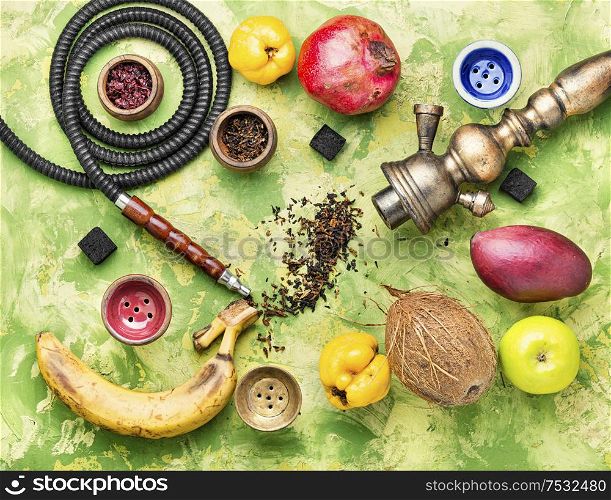 Hookah tobacco with the taste of mango, pomegranate and quince.Tobacco with the aroma of tropical fruits.Oriental smoking shisha. Tobacco shisha on fruit