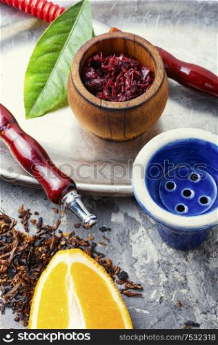 Hookah tobacco with the taste of orange.Tobacco with the aroma of tropical fruits.Turkish smoking kalian. Orange hookah tobacco