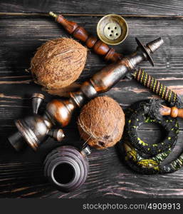 Hookah with coconut flavor. Stylish Oriental hookah and ripe tropical coconut