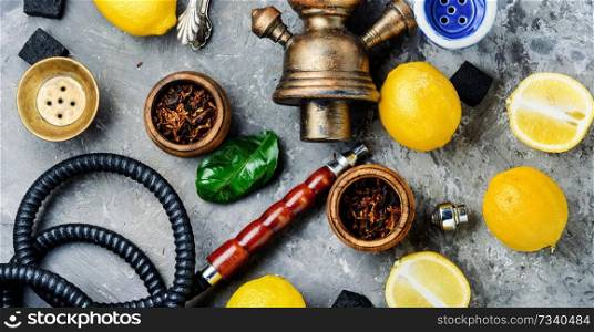 Hookah with fruit aroma for relax.Shisha hookah.Hookah with lemon.Lime tobacco. Smoking hookah with lemon flavor