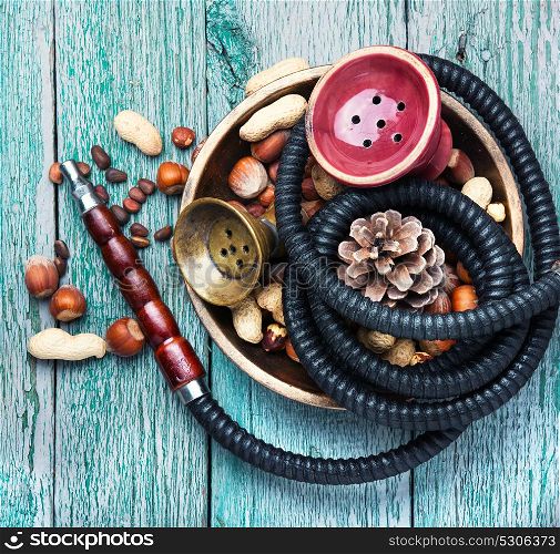 Hookah with nut tobacco taste. Details of a smoking shisha with tobacco flavor of hazelnut and almonds.Hookah background
