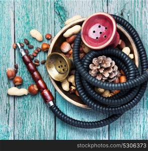 Hookah with nut tobacco taste. Details of a smoking shisha with tobacco flavor of hazelnut and almonds.Hookah background