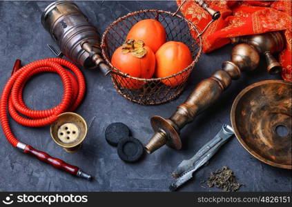 Hookah with persimmon. Smoking hookah with the tobacco flavor with the taste of ripe persimmons