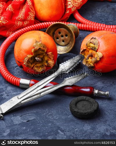 Hookah with persimmon. Smoking hookah with the tobacco flavor with the taste of ripe persimmons