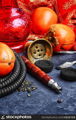 Hookah with persimmon. Smoking hookah with the tobacco flavor with the taste of ripe persimmons