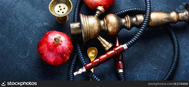 hookah with pomegranate. Exotic smoking shisha in east style with tobacco aroma of pomegranate.Fruit hookah