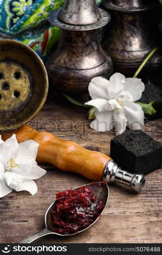 hookah with taste of Jasmine. Smoking Turkish Shisha and spoon with Jasmine hookah tobacco