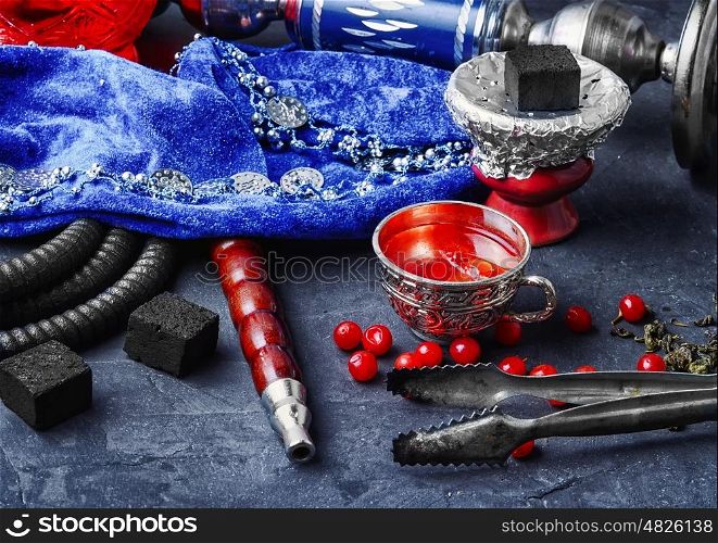 hookah with tea. Turkish hookah and tea with berries on stone background