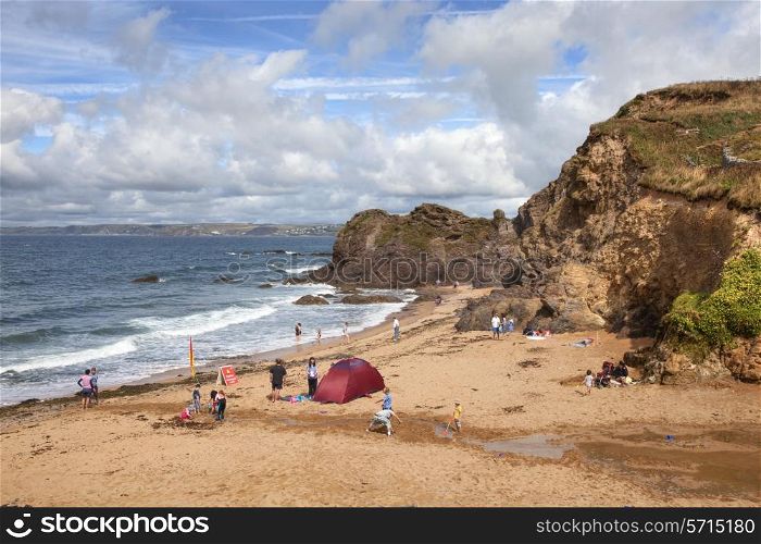 Hope Cove, Devon, UK ? August 16, 2013: Holiday makers enjoying the summer sun on the popular beach at Hope Cove.