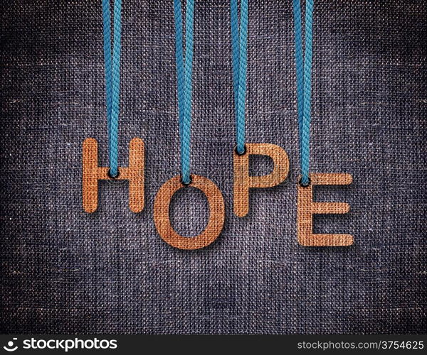 Hope Letters hanging strings with blue sackcloth background.. Hope