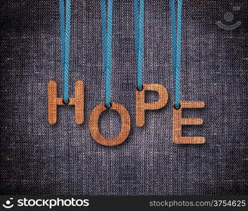 Hope Letters hanging strings with blue sackcloth background.. Hope