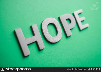                                hope word with wooden letters on the green background