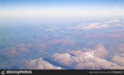 Horizon of the planet earth and Alps mountain tops. View from spaceship or plane.. Horizon of the planet earth.