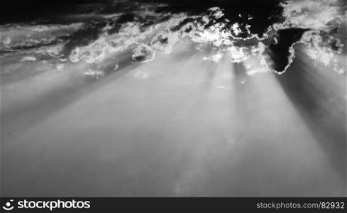 Horizontal black and white cloudscape with sun rays background backdrop. Horizontal black and white cloudscape with sun rays background b