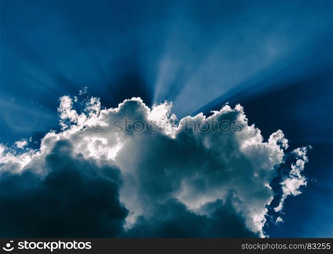 Horizontal blue dramatic cloudscape with rays of light abstraction. Horizontal blue dramatic cloudscape with rays of light abstracti