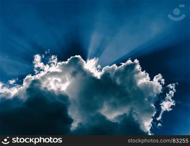 Horizontal blue dramatic cloudscape with rays of light abstraction. Horizontal blue dramatic cloudscape with rays of light abstracti