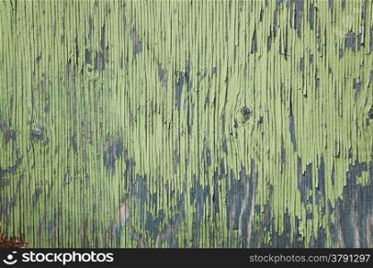 horizontal board with peeling green and blue paint