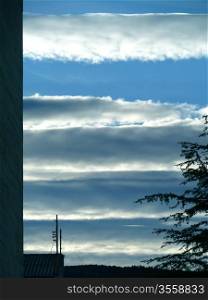 horizontal cloud stripes against a blue sky