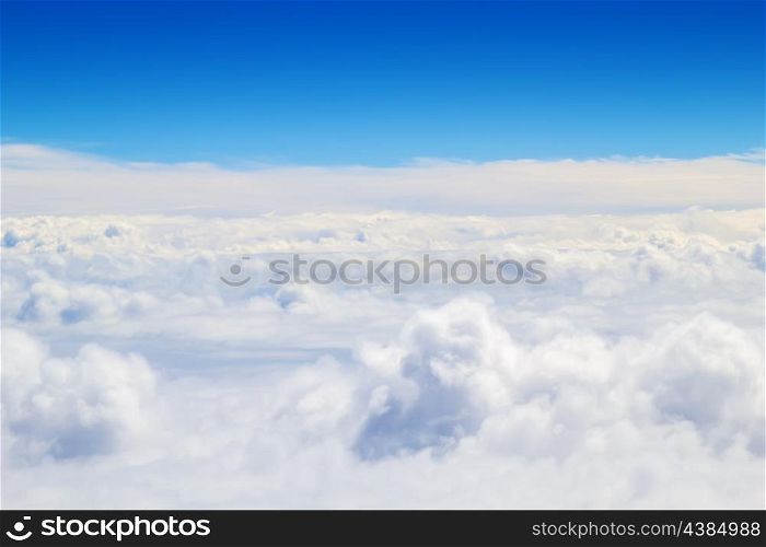 Horizontal cloudscape scenery with blue sky above.