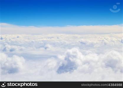 Horizontal cloudscape scenery with blue sky above.