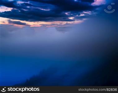 Horizontal dramatic clouds in mountains landscape backdrop