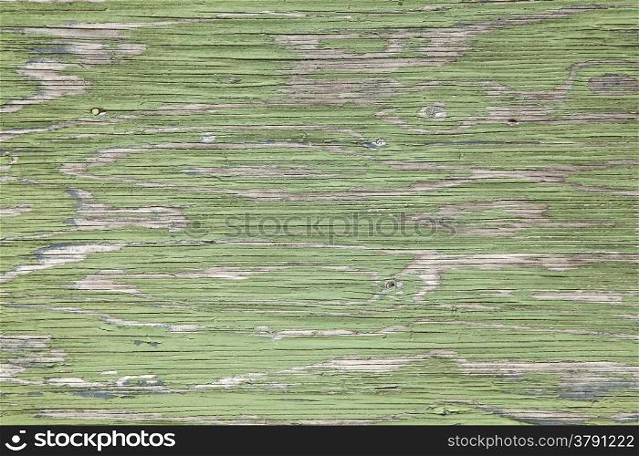 horizontal grey board with peeling green paint