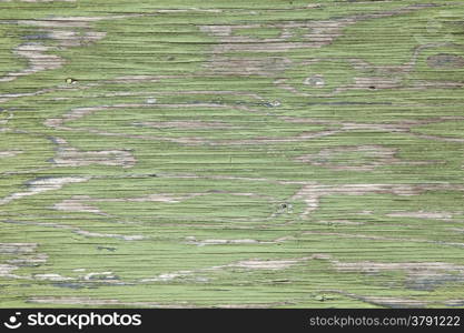 horizontal grey board with peeling green paint