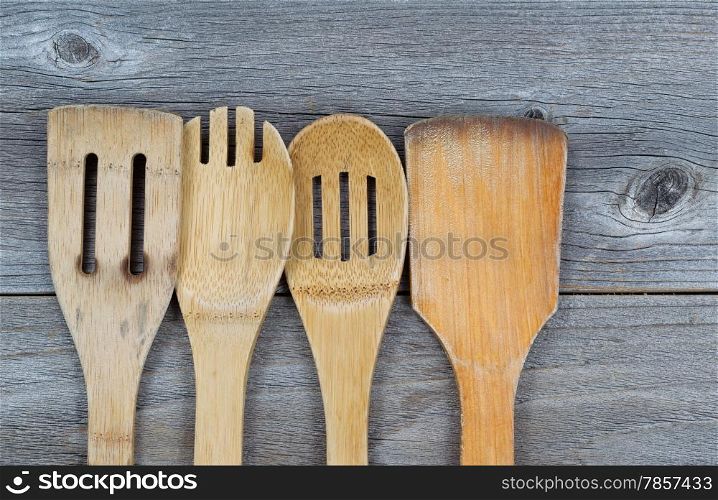 Horizontal image of old wooden cooking utensils on rustic wood