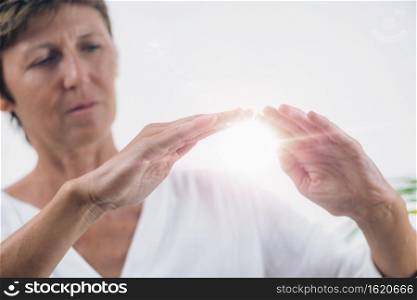 Horizontal image of professional Reiki healer doing Reiki distance healing treatment. Alternative therapy concept