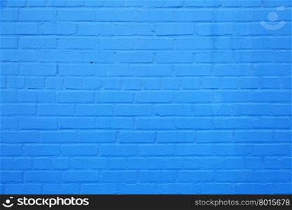 horizontal part of bright sky blue painted brick wall