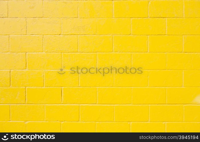 horizontal part of bright yellow painted brick block wall