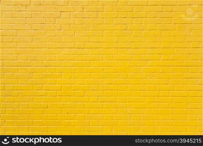 horizontal part of bright yellow painted brick wall
