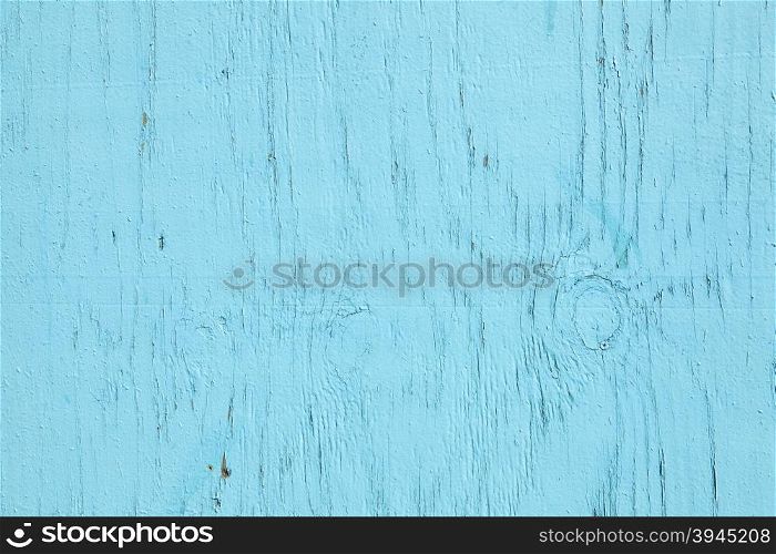 horizontal part of old wood with fading cracked turqoise paint