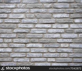 horizontal part of wall consisting of grey silver bricks