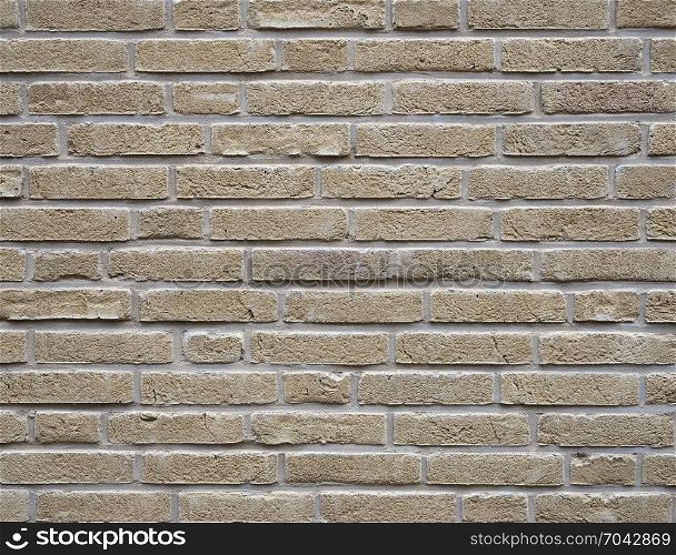 horizontal part of yellow creme brick wall with cement joints