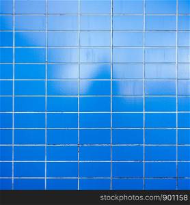 horizontal pattern of bright blue dirty tiles on square image