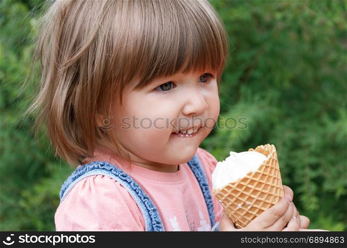 Horizontal photo of cute girl are eating icecream in summer time