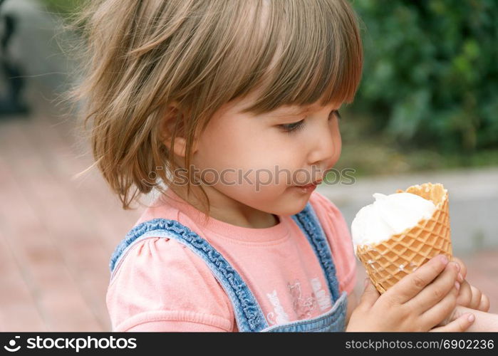 Horizontal photo of cute girl are eating icecream in summer time