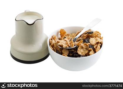 Horizontal photo of grain cereal, raisins, spoon in white bowl and milk with pourer isolated on white