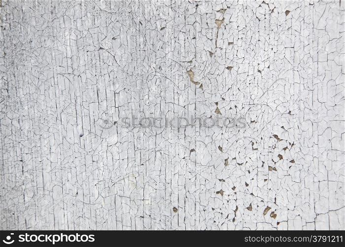 horizontal picture of board with peeling white and grey paint