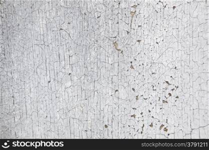 horizontal picture of board with peeling white and grey paint