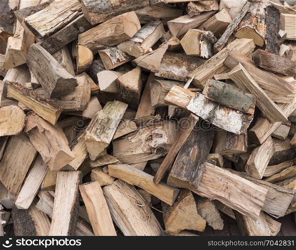 horizontal picture of firewood ready to burn in closeup