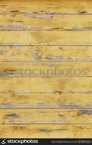 horizontal picture of old horizontal planks with peeling yellow paint