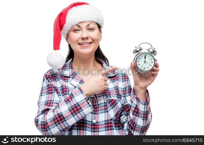 Horizontal portrait of a beautiful girl in a Santa cap in the ne. Horizontal portrait of a beautiful girl in a Santa cap in the new year with an alarm clock