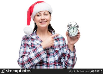 Horizontal portrait of a beautiful girl in a Santa cap in the ne. Horizontal portrait of a beautiful girl in a Santa cap in the new year with an alarm clock
