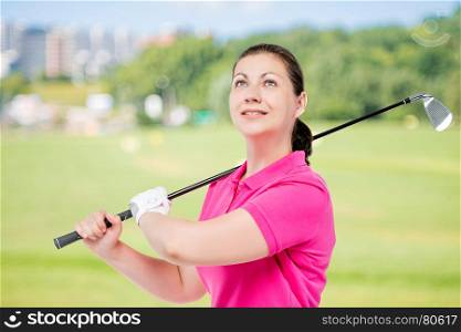 Horizontal portrait of a successful golfer with equipment for playing golf on a background of golf courses