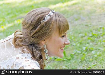 Horizontal portrait of profile girl with diadem on green background