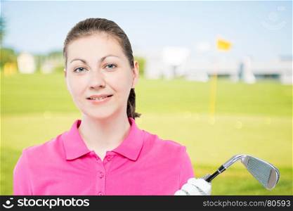 horizontal portrait of the girl with a golf club in a pink polo shirt